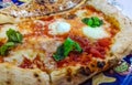 Italian pizza with mozzarella, basil and tomato