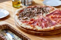 Italian pizza with mushrooms and parma ham