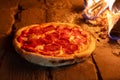 Italian pizza pepperoni in a wood-fired oven Royalty Free Stock Photo