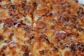 Italian pizza with pieces of pastrami, meat, beef and salami, with mozzarella cheese and peppers, baked pizza with ketchup ready Royalty Free Stock Photo