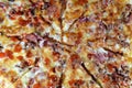Italian pizza with pieces of pastrami, meat, beef and salami, with mozzarella cheese and peppers, baked pizza with ketchup ready Royalty Free Stock Photo