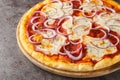 Italian Pizza pugliese topped with tomato sauce, melted cheese and lots of red onion close-up on a wooden board. Horizontal Royalty Free Stock Photo