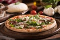 Italian Pizza with rocket salad on wooden table