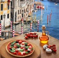 Italian pizza in Venice against canal, Italy