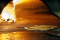 Italian pizza in a wood burning oven Royalty Free Stock Photo