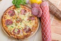 ITALIAN PIZZA on wooden table. True hot tasty PIZZA with salami, mushrooms, basil, olives, pepper and cheese. Nice for menu Royalty Free Stock Photo