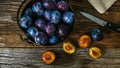 Italian plums inside rustic bowl and wooden table