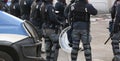 Italian police officers in riot gear with the word POLIZIA meani