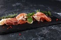 Italian prosciutto crudo or jamon with rosemary. Raw ham appetizer..