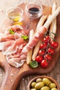 Italian prosciutto ham grissini bread sticks tomato olive oil