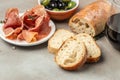 Italian prosciutto, jamon, ham and olives and glass of red wine bruschetta. Tapas, antipasti. Long banner format. top view