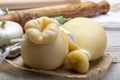 Italian provolone or provola caciocavallo hard cheeses in teardrop form served on old paper close up