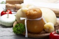 Italian provolone or provola caciocavallo hard and smoked cheeses in teardrop form served on olive tree board close up