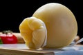 Italian provolone or provola caciocavallo hard and smoked cheeses in teardrop form served on white marble plate close up