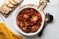 Italian rabbit stew cooked with white wine, tomatoes and olives,