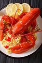 Italian recipe of spaghetti with boiled lobster, tomatoes, lemon Royalty Free Stock Photo