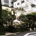 A Italian restaurant cuisine hidden flowers tree all over house exterior omotesando tokyo japan