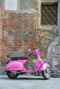 Italian retro motorcycle Vespa parked near bricks wall