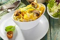 Italian ribbon noodles with mushrooms and salad