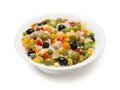 Italian rice salad in a white porcelain salad bowl isolated on a white background.