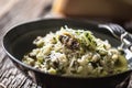 Italian risotto zucchini mushrooms and parmesan in dark plate Royalty Free Stock Photo