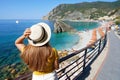 Italian Riviera. Pretty girl with hat on promenade looking at Monterosso al Mare village on Cinque Terre, Italy Royalty Free Stock Photo
