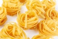 Italian rolled Raw noodles. Pasta on white background . Egg homemade dry ribbon noodles, long rolled macaroni or uncooked Royalty Free Stock Photo