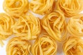 Italian rolled Raw noodles. Pasta on white background . Egg homemade dry ribbon noodles, long rolled macaroni or uncooked Royalty Free Stock Photo