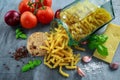 Italian Rotini pasta in vintage glass jar with vine ripe tomatoes, cheese, garlic, red onions and fresh basil leaves Royalty Free Stock Photo