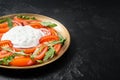 Italian salad caprese with cheese stracciatella, tomatoes and arugula. Black background. Top view. Copy space Royalty Free Stock Photo