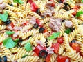 Italian salad: cold pasta, chopped tomatoes, black olives, tuna slices