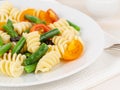 Italian salad with fusilli paste tomatoes, olives, green beans, part of, side view, close up Royalty Free Stock Photo