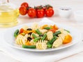 Italian salad with fusilli paste tomatoes, olives, green beans, side view, close up Royalty Free Stock Photo