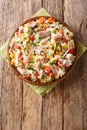 Italian salad of rice, tuna and fresh vegetables close-up in a plate. vertical top view