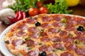 Italian salami pizza on table Royalty Free Stock Photo