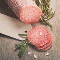 Italian salami sausage slices with rosemary and sea salt Royalty Free Stock Photo