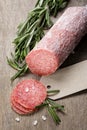 Italian salami sausage slices with rosemary and sea salt Royalty Free Stock Photo