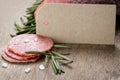 Italian salami sausage slices with rosemary and sea salt Royalty Free Stock Photo