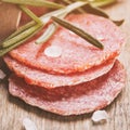 Italian salami sausage slices with rosemary and sea salt Royalty Free Stock Photo