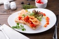 Italian sandwich bruschetta with shrimps served on white plate Royalty Free Stock Photo