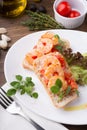 Italian sandwich bruschetta with shrimps served on white plate Royalty Free Stock Photo