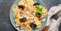 Italian seafood pasta spaghetti with mussels, shrimps, clams in tomato sauce with green basil on plate on rustic blue Royalty Free Stock Photo