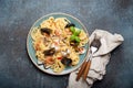 Italian seafood pasta spaghetti with mussels, shrimps, clams in tomato sauce with green basil on plate on rustic blue Royalty Free Stock Photo