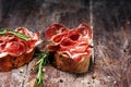 Italian sliced cured coppa with spices. Raw ham. Crudo or jamon with rosemary Royalty Free Stock Photo
