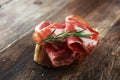 Italian sliced cured coppa with spices. Raw ham. Crudo or jamon with rosemary Royalty Free Stock Photo