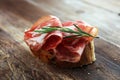 Italian sliced cured coppa with spices. Raw ham. Crudo or jamon with rosemary Royalty Free Stock Photo