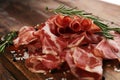 Italian sliced cured coppa with spices. Raw ham. Crudo or jamon with rosemary Royalty Free Stock Photo