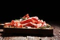 Italian sliced cured coppa with spices. Raw ham. Crudo or jamon with rosemary Royalty Free Stock Photo