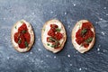 Italian snack or appetizer from bruschetta, cream cheese and sun dried tomatoes. Top view. Royalty Free Stock Photo