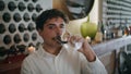 Italian sommelier tasting red wine in goblet close up. Winemaker making sip.